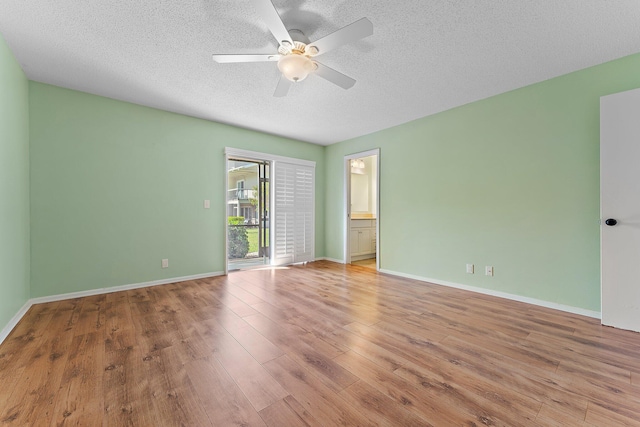 empty room with ceiling fan, light hardwood / wood-style floors, and a textured ceiling