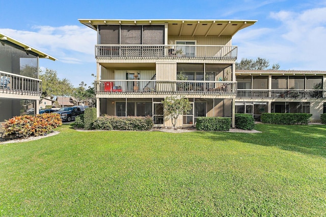 rear view of property with a yard