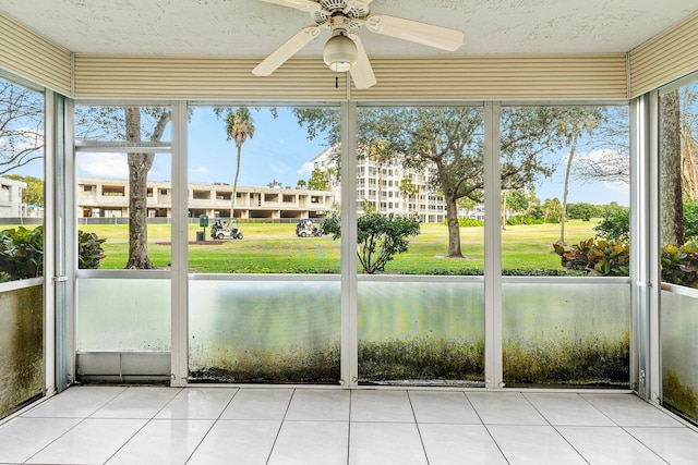 unfurnished sunroom with ceiling fan and a healthy amount of sunlight