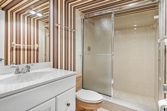 bathroom with vanity, an enclosed shower, and toilet