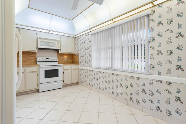 kitchen featuring white cabinets, ceiling fan, light tile patterned flooring, and white appliances