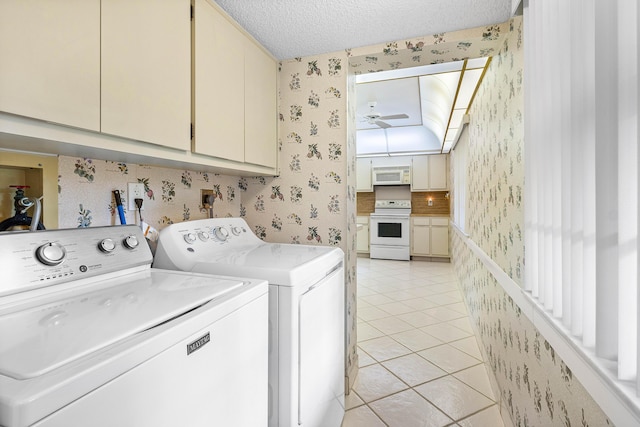 washroom with cabinets, a textured ceiling, ceiling fan, washer and dryer, and light tile patterned flooring