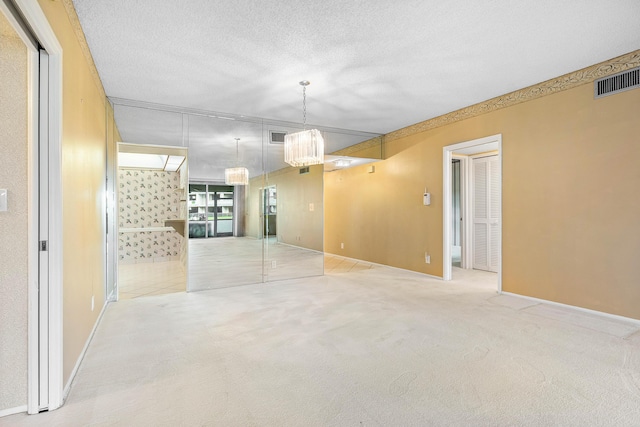 unfurnished room featuring carpet flooring and a textured ceiling