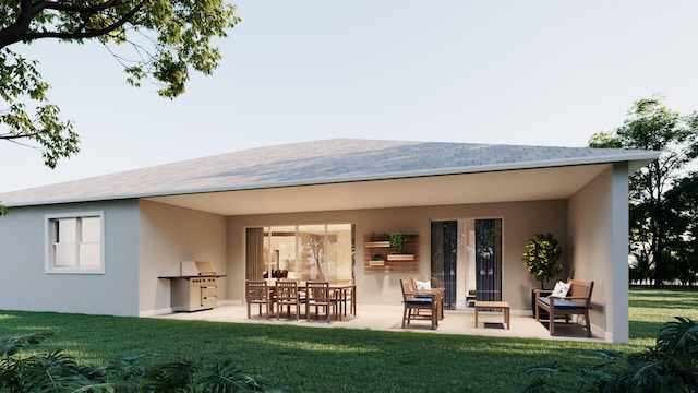 back of property with a yard, an outdoor kitchen, and a patio area