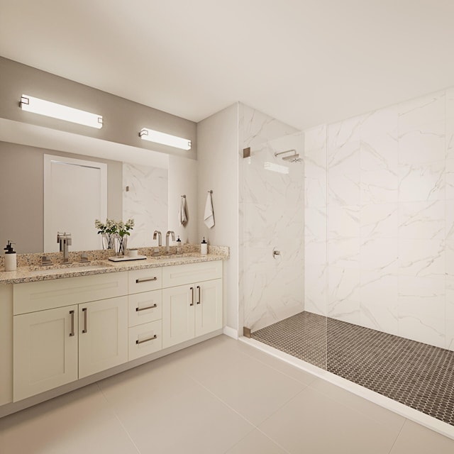 bathroom with tiled shower, vanity, and tile patterned floors