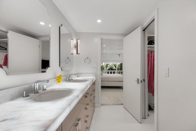 bathroom with tile patterned flooring and vanity