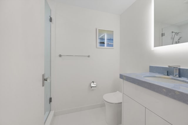 bathroom with tile patterned flooring, vanity, toilet, and a shower with door