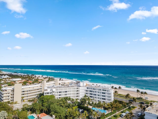 drone / aerial view with a beach view and a water view