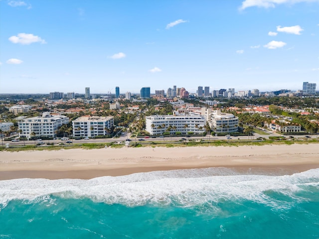 bird's eye view with a water view and a beach view