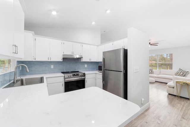 kitchen featuring stainless steel appliances, white cabinetry, and sink