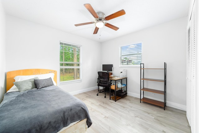 bedroom with ceiling fan, a closet, and light wood-type flooring