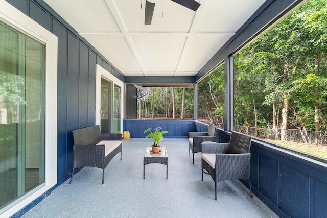 sunroom / solarium featuring ceiling fan and plenty of natural light