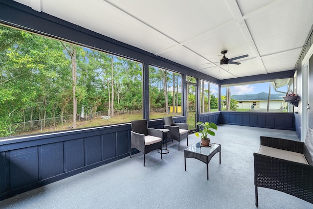 sunroom / solarium featuring ceiling fan