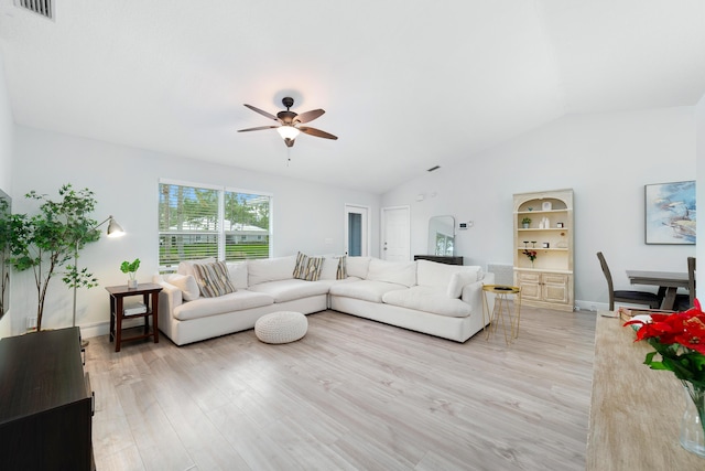 living room featuring ceiling fan, lofted ceiling, and light wood-type flooring