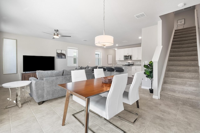 tiled dining room with ceiling fan