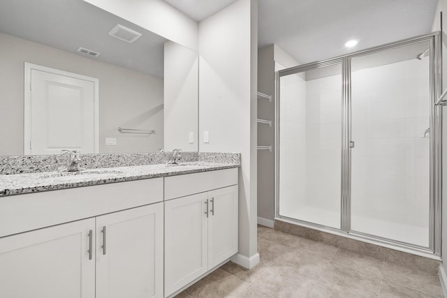 bathroom featuring tile patterned floors, vanity, and an enclosed shower