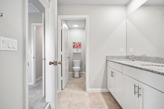 bathroom with tile patterned floors, vanity, and toilet