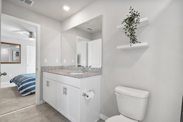 bathroom featuring ceiling fan, tile patterned flooring, vanity, and toilet