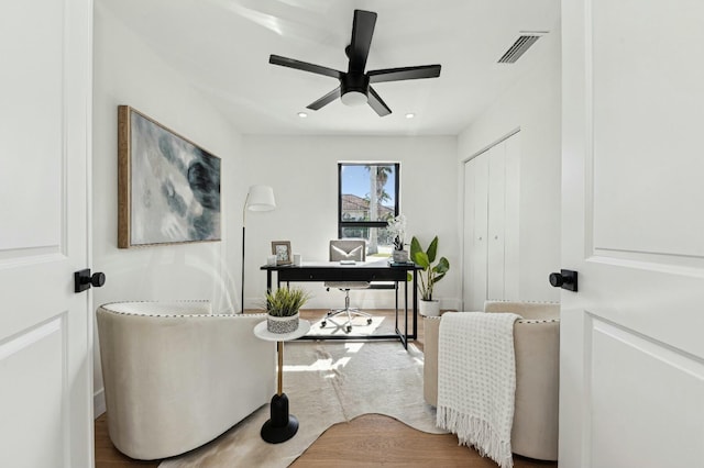 sitting room featuring ceiling fan and hardwood / wood-style flooring