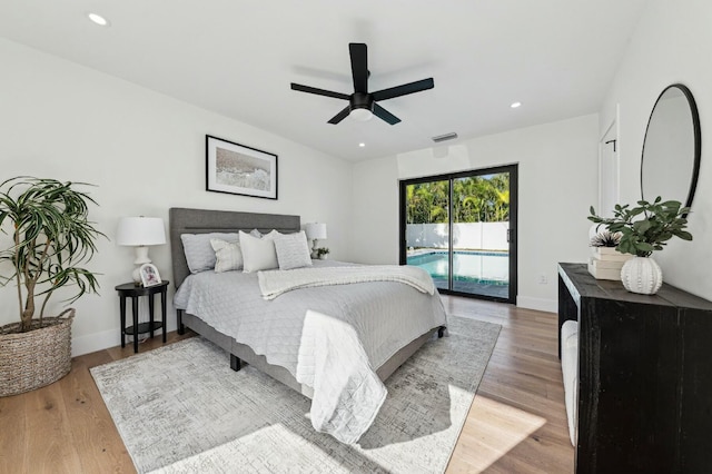 bedroom with hardwood / wood-style floors, access to outside, and ceiling fan