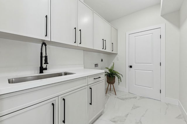 laundry room with electric dryer hookup, cabinets, sink, and hookup for a washing machine