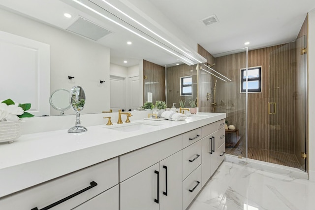 bathroom featuring vanity and a shower with shower door