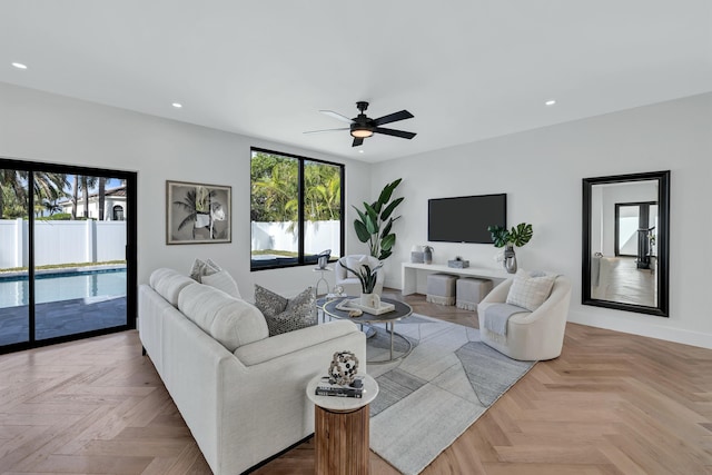 living room featuring light parquet floors, plenty of natural light, and ceiling fan