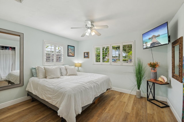 bedroom with ceiling fan and hardwood / wood-style floors