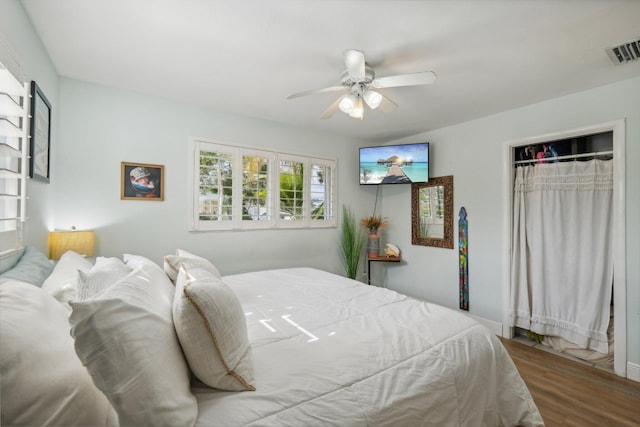 bedroom featuring ceiling fan, wood-type flooring, and a closet