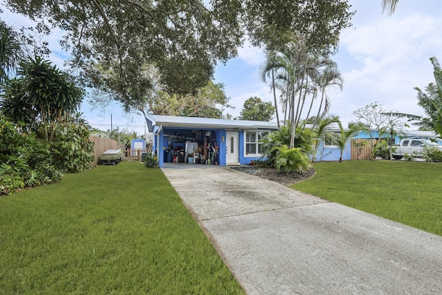 single story home featuring a front lawn and a carport