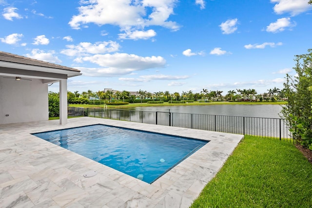 view of pool featuring a patio and a water view