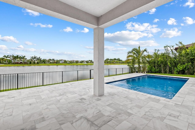 view of pool featuring a water view and a patio