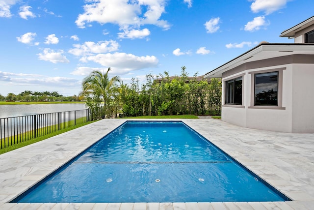 view of pool with a patio and a water view