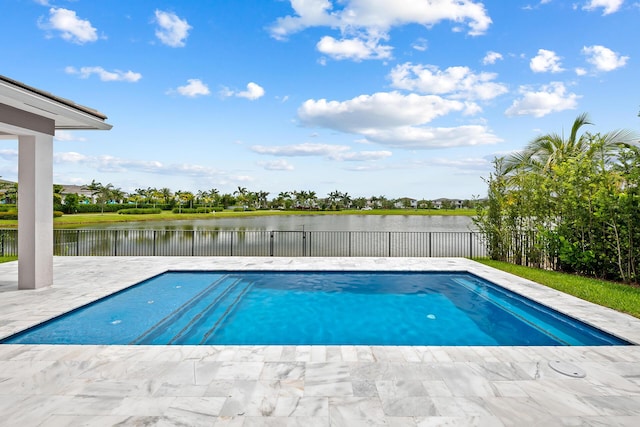 view of swimming pool with a patio area and a water view