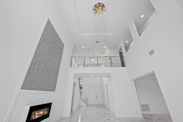 entrance foyer with a chandelier and a high ceiling