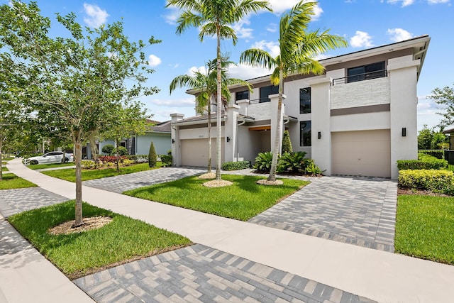 modern home featuring a garage and a front yard