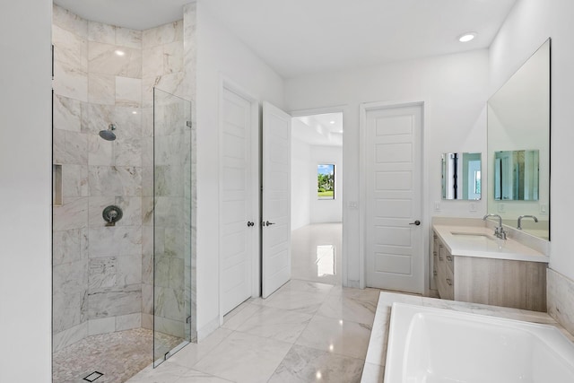 bathroom featuring vanity and separate shower and tub