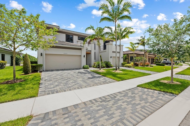 view of front of property featuring a garage and a front yard