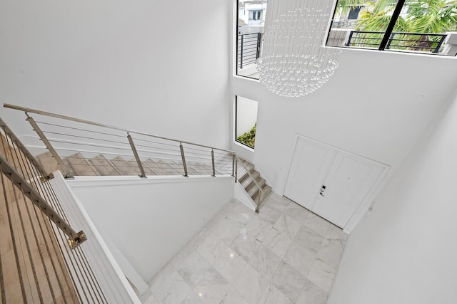 stairs featuring an inviting chandelier