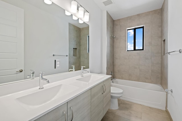 full bathroom featuring tile patterned flooring, vanity, toilet, and tiled shower / bath