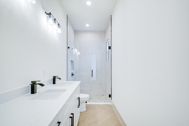 bathroom with a sink, toilet, recessed lighting, and a stall shower
