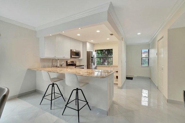 kitchen with light stone counters, crown molding, appliances with stainless steel finishes, kitchen peninsula, and white cabinets