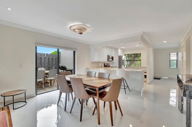 dining room with ceiling fan and ornamental molding