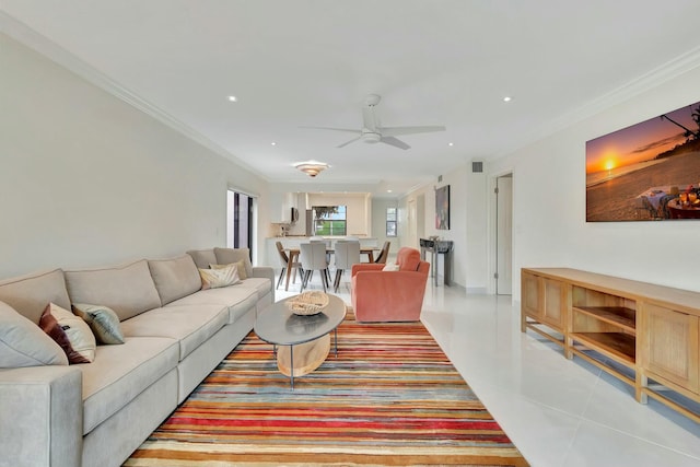 living room with light tile patterned floors, ceiling fan, and crown molding