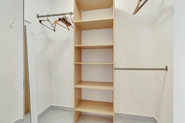 spacious closet featuring tile patterned flooring