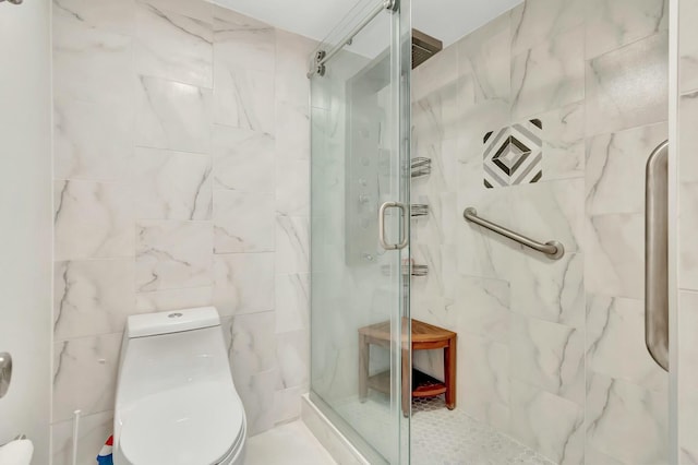 bathroom featuring toilet, a shower with shower door, and tile walls