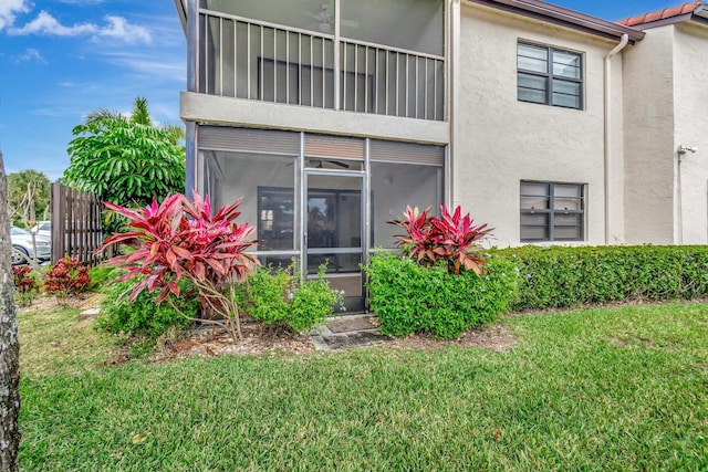 rear view of property with a lawn