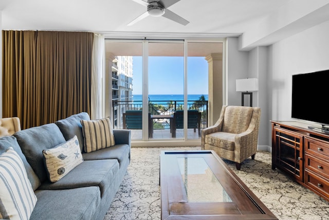 living room with ceiling fan and expansive windows