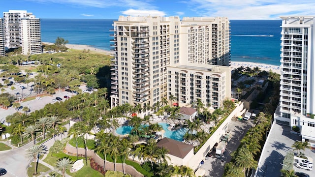 drone / aerial view with a water view and a beach view