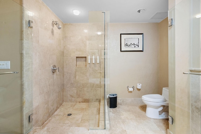 bathroom featuring toilet and walk in shower